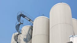 Industrial-distillating-columns-in-factory-site-with-spiral-stairs