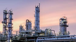 Distillation-tower-in-factory-on-sky-sunset-background