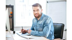 male engineer sitting at computer desk